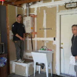 Clean tankless water heater installation in a garage