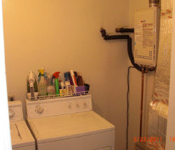Tankless water heater installed in laundry space