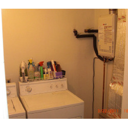 Tankless water heater installed in laundry space
