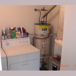 water heater next to laundry machines