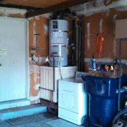 Classic water heater near washing machine