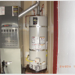 standard water heater installation next to furnace